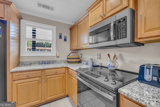 26-105 Midway Street Unit #108But Door #105, Helen, GA 30545 - kitchen with stainless steel microwave, range with electric cooktop, light tile patterned floors, and light stone countertops