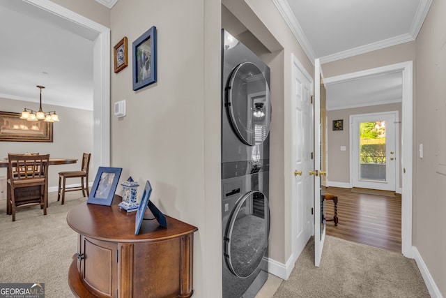 26-105 Midway Street Unit #108But Door #105, Helen, GA 30545 - washroom featuring stacked washer / dryer, light colored carpet, baseboards, a chandelier, and crown molding