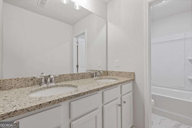 688 Shoals Trl, Dallas, GA 30132 - full bathroom featuring double vanity, toilet, marble look tile flooring, and shower / tub combination