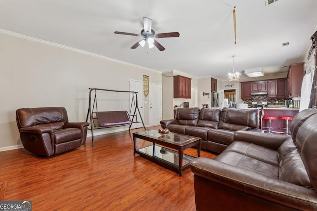 1093 Forest View Ln SW, Lilburn, GA 30047 - living room with wood finished floors, ceiling fan, baseboards, a chandelier, and crown molding