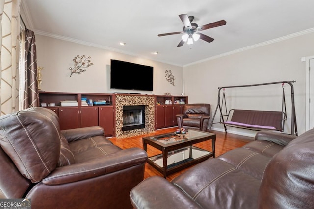 1093 Forest View Ln SW, Lilburn, GA 30047 - living room featuring wood finished floors, ceiling fan, ornamental molding, a tile fireplace, and baseboards