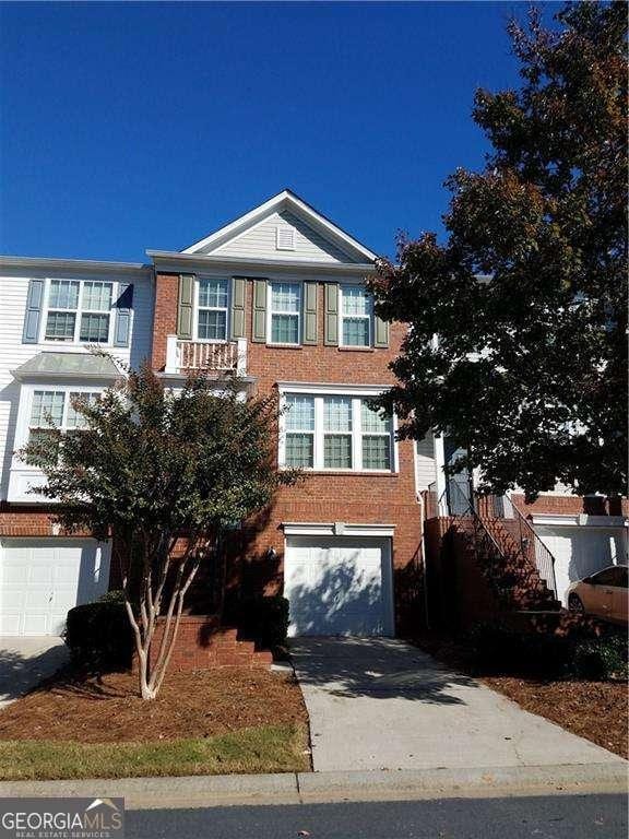 1379 Thornborough Dr, Alpharetta, GA 30004 - view of front of property with an attached garage, concrete driveway, brick siding, and stairs