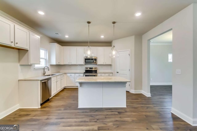 407 Shoals Trl, Dallas, GA 30132 - kitchen featuring appliances with stainless steel finishes, a sink, baseboards, white cabinetry, and recessed lighting