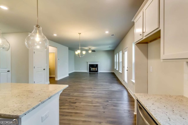 407 Shoals Trl, Dallas, GA 30132 - kitchen with recessed lighting, open floor plan, dark wood finished floors, a fireplace, and light stone counters