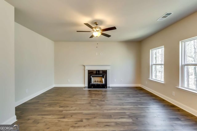 407 Shoals Trl, Dallas, GA 30132 - unfurnished living room with a fireplace, dark wood-style floors, ceiling fan, and baseboards
