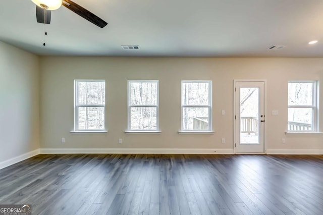 407 Shoals Trl, Dallas, GA 30132 - spare room featuring dark wood-style flooring, baseboards, and healthy amount of natural light