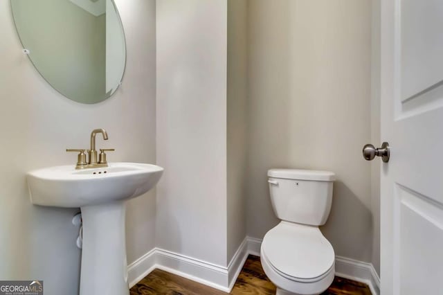 407 Shoals Trl, Dallas, GA 30132 - half bathroom with baseboards, toilet, and wood finished floors