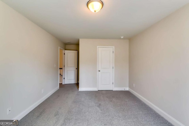 407 Shoals Trl, Dallas, GA 30132 - unfurnished bedroom featuring carpet and baseboards