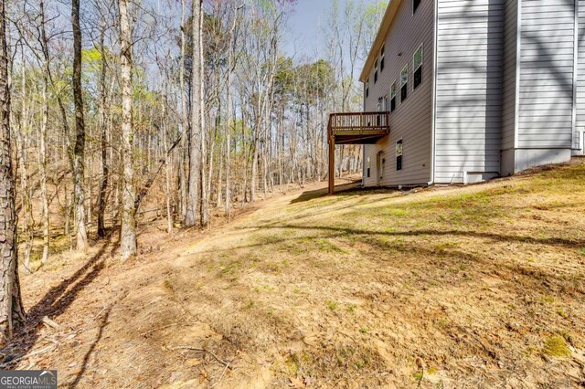 407 Shoals Trl, Dallas, GA 30132 - view of green lawn with a deck