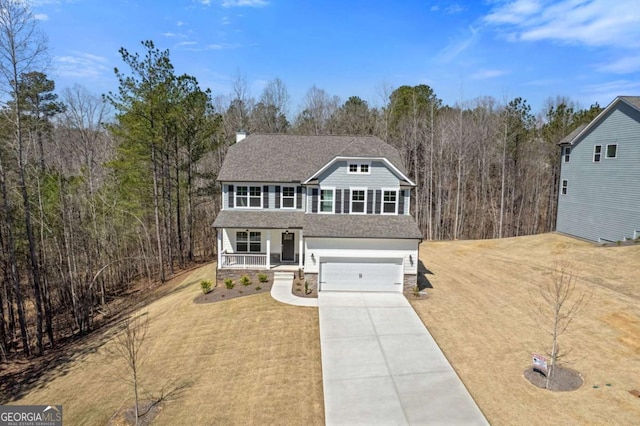 457 Principal Meridian Dr, Dallas, GA 30132 - view of front of property with covered porch, an attached garage, concrete driveway, a forest view, and stone siding