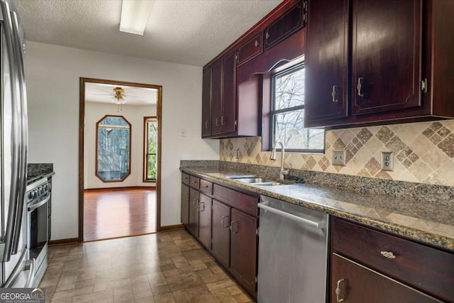 3966 N Indian Cir NW, Kennesaw, GA 30144 - kitchen featuring stainless steel appliances, backsplash, ceiling fan, a textured ceiling, and stone finish flooring