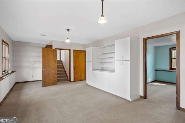 3966 N Indian Cir NW, Kennesaw, GA 30144 - unfurnished living room with light colored carpet and stairway
