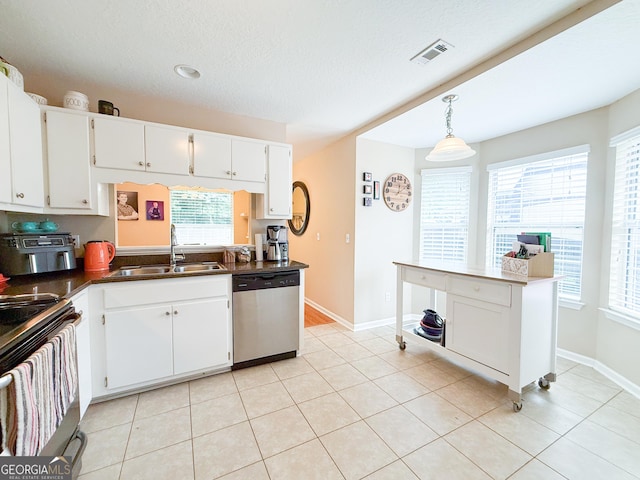 521 Lake Jordan Blvd W, Kingsland, GA 31548 - kitchen with stainless steel dishwasher, electric range oven, dark countertops, and white cabinetry