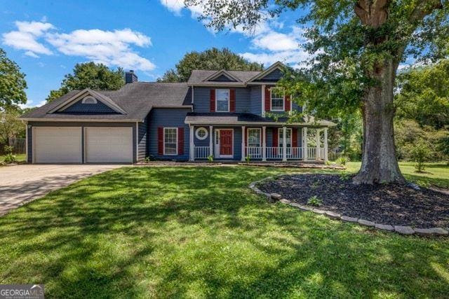 2505 Tiffany Ct, Conyers, GA 30013 - view of front facade featuring a garage, a front yard, driveway, and a porch