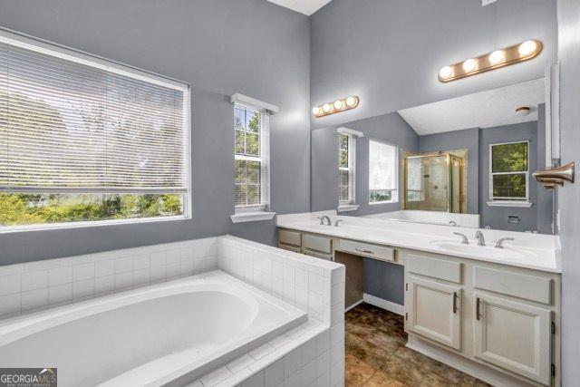 2505 Tiffany Ct, Conyers, GA 30013 - bathroom with a bath, double vanity, a shower stall, and tile patterned flooring