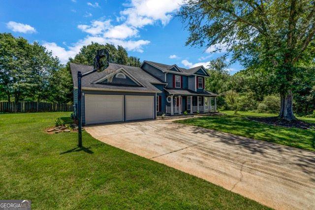 2505 Tiffany Ct, Conyers, GA 30013 - traditional-style home featuring a garage and concrete driveway