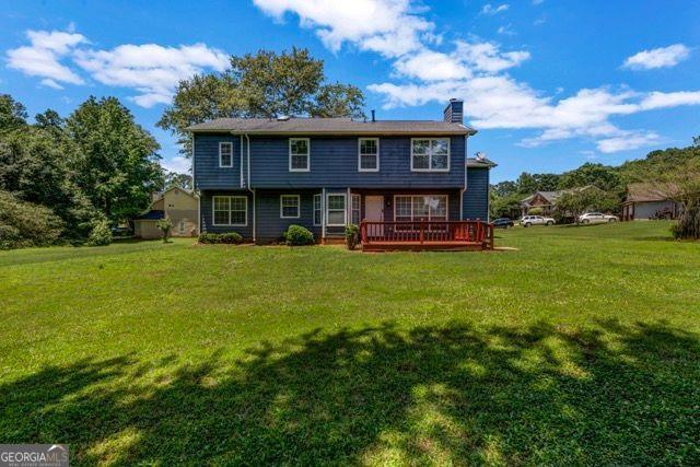 2505 Tiffany Ct, Conyers, GA 30013 - rear view of house with a lawn, a chimney, and a deck