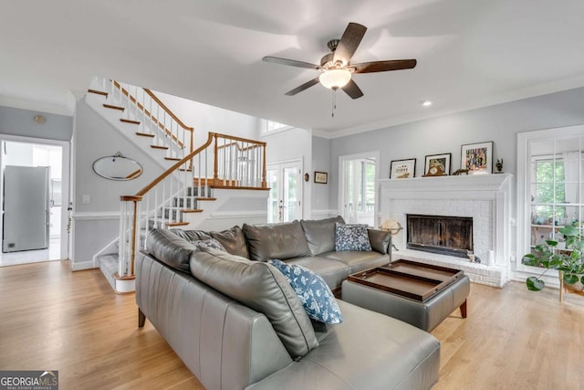 3250 Cobbs Farm Trl NW, Marietta, GA 30064 - living room featuring stairway, plenty of natural light, ceiling fan, light wood-style floors, and ornamental molding