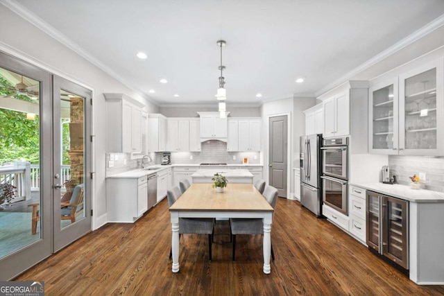 1596 Fearn Cir NE, Brookhaven, GA 30319 - kitchen featuring beverage cooler, stainless steel appliances, decorative backsplash, light countertops, and crown molding
