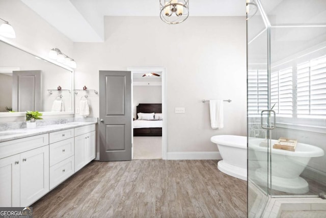 1596 Fearn Cir NE, Brookhaven, GA 30319 - bathroom with double vanity, ensuite bathroom, a freestanding tub, wood finished floors, and a stall shower