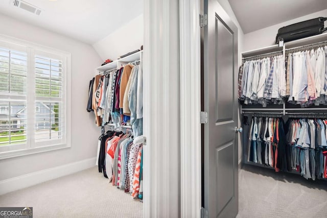 1596 Fearn Cir NE, Brookhaven, GA 30319 - spacious closet featuring carpet flooring and vaulted ceiling