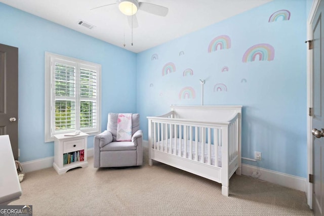 1596 Fearn Cir NE, Brookhaven, GA 30319 - carpeted bedroom featuring a crib, a ceiling fan, and baseboards