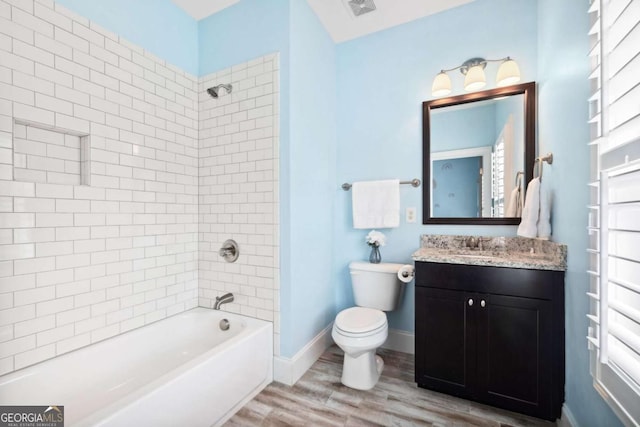 1596 Fearn Cir NE, Brookhaven, GA 30319 - bathroom featuring wood finished floors, toilet, vanity, shower / washtub combination, and baseboards