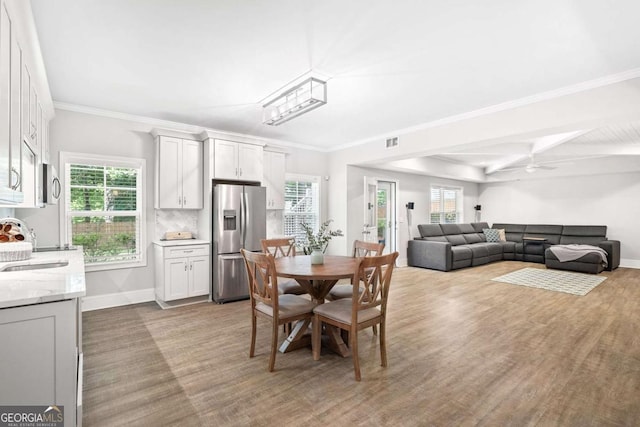 1596 Fearn Cir NE, Brookhaven, GA 30319 - dining room featuring plenty of natural light, beamed ceiling, ornamental molding, baseboards, and a ceiling fan