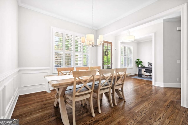 1596 Fearn Cir NE, Brookhaven, GA 30319 - dining area with ornamental molding, dark wood-type flooring, a chandelier, a wainscoted wall, and a decorative wall