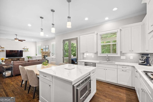 1596 Fearn Cir NE, Brookhaven, GA 30319 - kitchen featuring appliances with stainless steel finishes, a sink, decorative backsplash, a center island, and ornamental molding