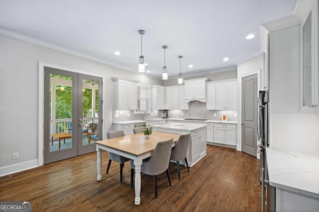1596 Fearn Cir NE, Brookhaven, GA 30319 - dining space with crown molding, french doors, dark wood-type flooring, recessed lighting, and baseboards
