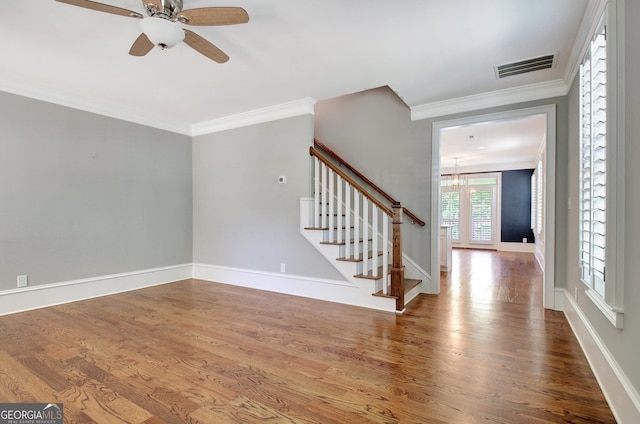 46 Horseshoe Bend Way, Senoia, GA 30276 - unfurnished living room with stairway, wood finished floors, a chandelier, crown molding, and a ceiling fan