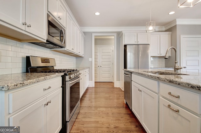 46 Horseshoe Bend Way, Senoia, GA 30276 - kitchen featuring appliances with stainless steel finishes, a sink, white cabinetry, ornamental molding, and baseboards