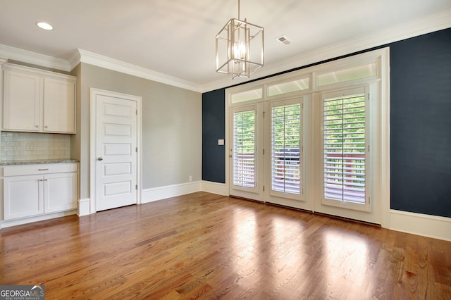 46 Horseshoe Bend Way, Senoia, GA 30276 - unfurnished dining area with a chandelier, crown molding, light wood finished floors, baseboards, and recessed lighting