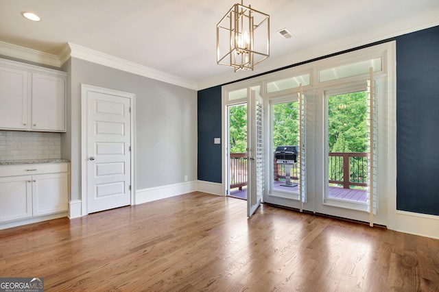 46 Horseshoe Bend Way, Senoia, GA 30276 - unfurnished dining area with crown molding, light wood finished floors, a chandelier, baseboards, and recessed lighting