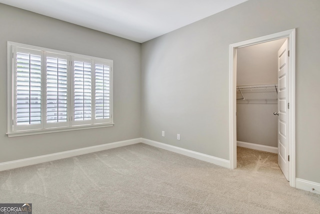 46 Horseshoe Bend Way, Senoia, GA 30276 - unfurnished bedroom with carpet, a walk in closet, baseboards, and a closet