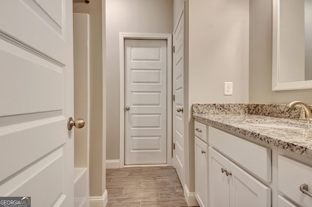 46 Horseshoe Bend Way, Senoia, GA 30276 - bathroom with vanity, wood finish floors, and baseboards