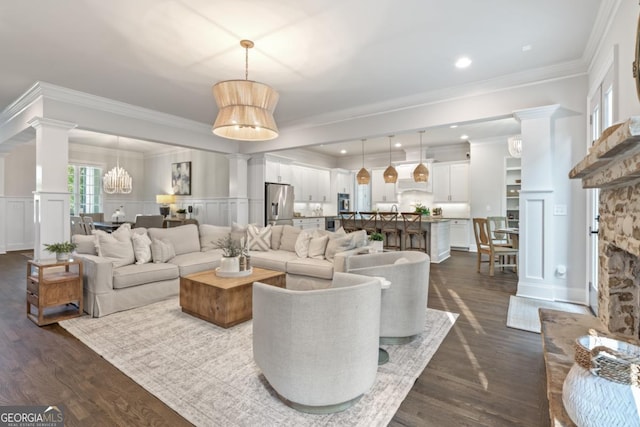 15626 Birmingham Hwy, Alpharetta, GA 30004 - living room with ornate columns, dark wood-style floors, ornamental molding, wainscoting, and a decorative wall