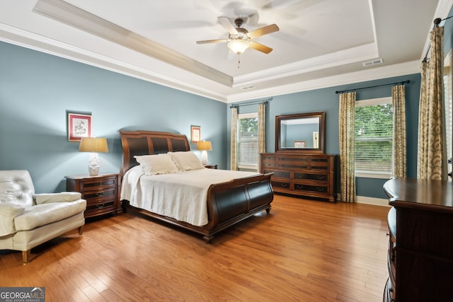 3491 Amerigo Dr, Buford, GA 30519 - bedroom with a raised ceiling, crown molding, hardwood / wood-style floors, and multiple windows