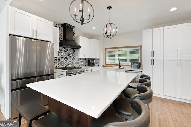 457 Monroe Ridge Rd, Sautee Nacoochee, GA 30571 - kitchen with freestanding refrigerator, a chandelier, backsplash, wall chimney range hood, and a sink