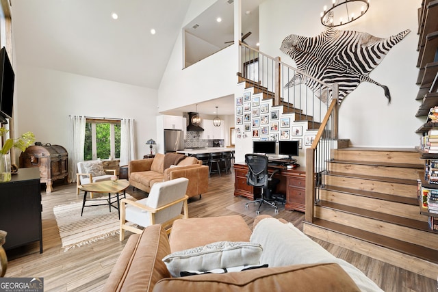 457 Monroe Ridge Rd, Sautee Nacoochee, GA 30571 - living area with high vaulted ceiling, stairway, a chandelier, light wood-style flooring, and recessed lighting