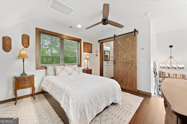 457 Monroe Ridge Rd, Sautee Nacoochee, GA 30571 - bedroom featuring a barn door, baseboards, wood finished floors, connected bathroom, and ceiling fan