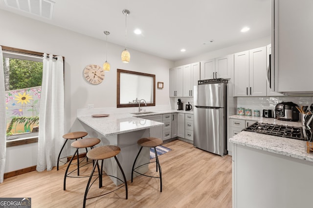 457 Monroe Ridge Rd, Sautee Nacoochee, GA 30571 - kitchen with stainless steel appliances, a sink, a peninsula, light stone countertops, and recessed lighting