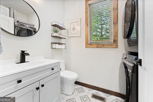 457 Monroe Ridge Rd, Sautee Nacoochee, GA 30571 - half bath with estacked washer and dryer, toilet, vanity, baseboards, and tile patterned floors