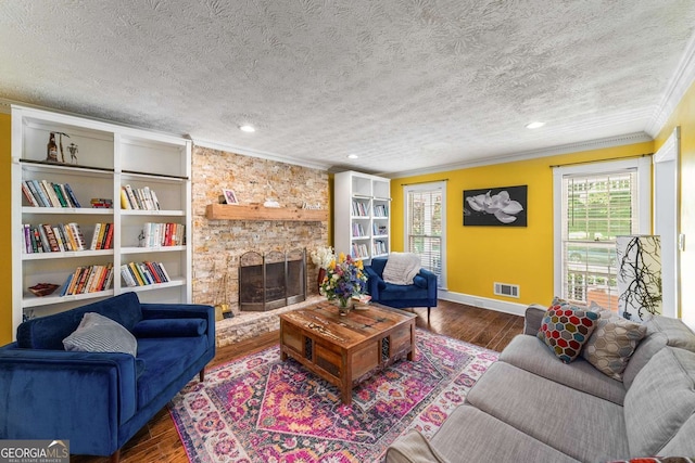 4259 Kings Troop Rd, Stone Mountain, GA 30083 - living area featuring crown molding, wood finished floors, a textured ceiling, a fireplace, and recessed lighting