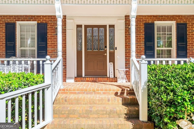 4259 Kings Troop Rd, Stone Mountain, GA 30083 - property entrance with a porch and brick siding