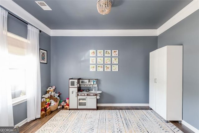 327 Nobleman Way, Canton, GA 30114 - rec room featuring wood finished floors and ornamental molding