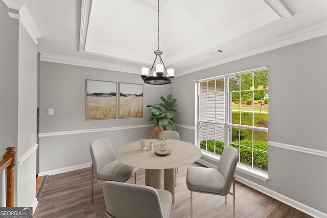 40 Wenham Ln, Sharpsburg, GA 30277 - dining space with ornamental molding, a chandelier, plenty of natural light, wood finished floors, and a textured ceiling