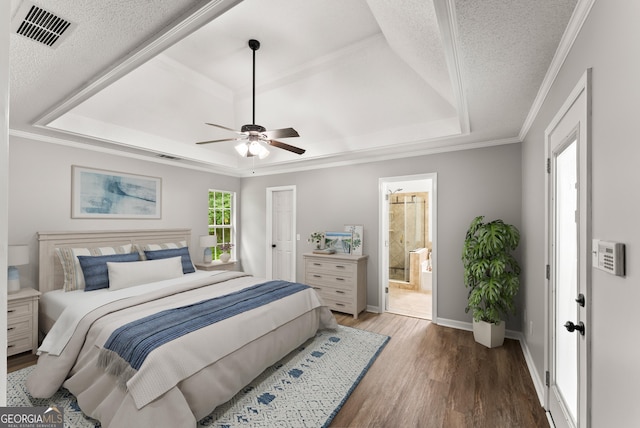 40 Wenham Ln, Sharpsburg, GA 30277 - bedroom with a tray ceiling, wood finished floors, baseboards, crown molding, and a textured ceiling