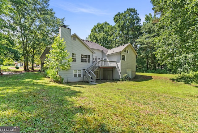 40 Wenham Ln, Sharpsburg, GA 30277 - back of property with stairway, a deck, a chimney, and a yard